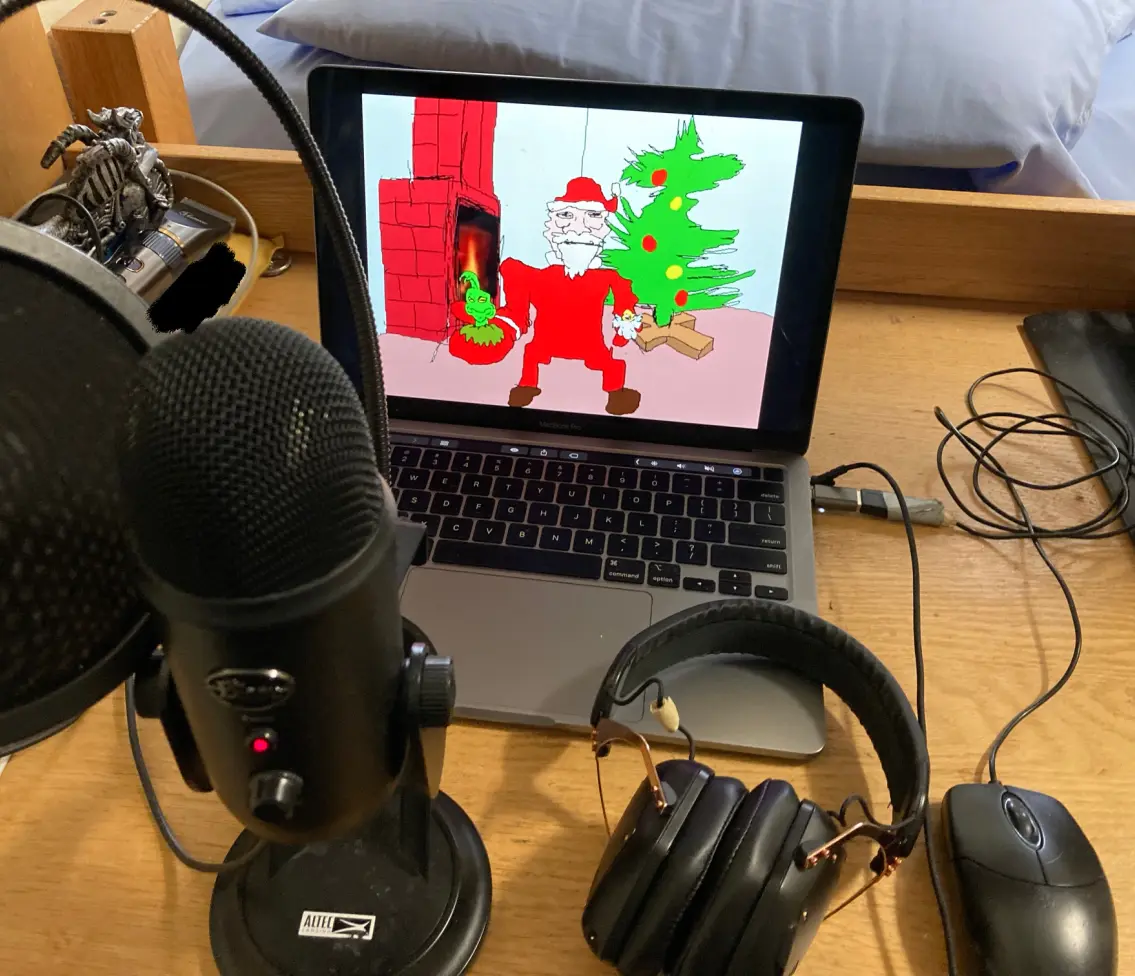 My poor laptop sitting on a desk with microphone and mouse